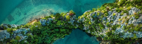 Drone view on rocks and canoes floating on turquoise water in the Halong Bay, Vietnam
