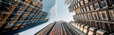 Highly detailed abstract wide angle view up towards the sky in the financial district and the ultra modern contemporary buildings with unique architecture on a cloudy day.