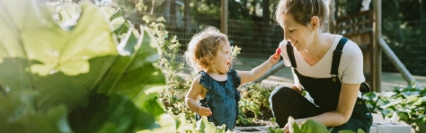 An image of a mother and her child in a garden.