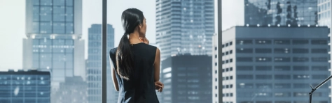 Women looking out window at buildings