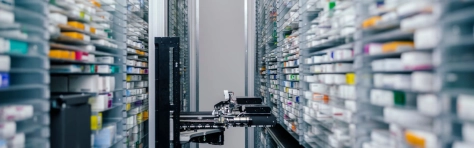 An image of medicine in shelves in a pharmacy