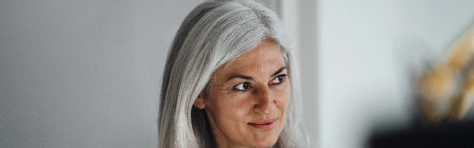 Mature female professional looking away at office
