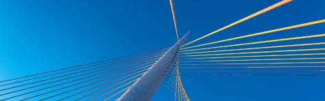 Bridge steel cable illuminated by a clear blue sky