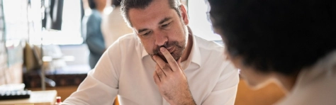Business owner sitting at table discussing the value of his business