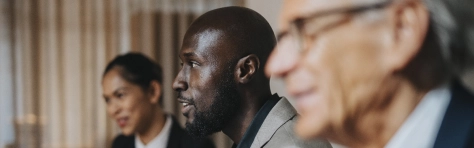 Businessman discussing ideas with male and female colleague during meeting