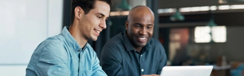 Two employees discussing HMRC's VAT guidance