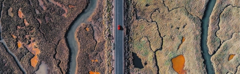 Car driving on road affected by tariff climate impact