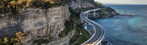 Australia, Bridge - Built Structure, Travel, Sea, Car, Cliff, Beach, Journey, Major Road, New South Wales, Balance, Wollongong, Diminishing Perspective, Coastal Road, Road, Sunlight, Tourism, Tree, Architecture, Scale, The Way Forward, Vacations, Elevated Road, Ideas, Curve, Eroded, Rock - Object
