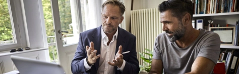 A financial adviser talking with his client discussing business and investments