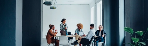 Image of businessman and businesswoman discussing ideas together during a meeting at the office