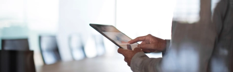 Businessman using tablet computer in conference room