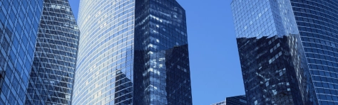 Close-up of modern office facades at business district at a clear sunny day