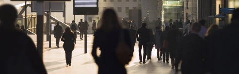 Businesswomen, businessmen and office workers in silhouette, arriving at La Defense business district of Paris, France.