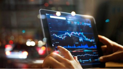 A consultant reviewing financial due diligence reports on a tablet