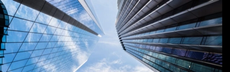 Low angle view of modern steel and glass skyscrapers with reflections, city