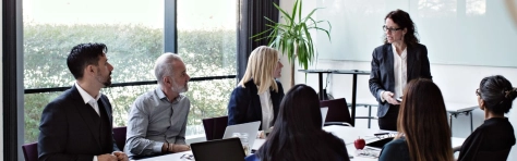 A group of professionals meeting as part of a board in a board room.