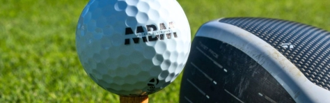 Golf club hitting gold ball