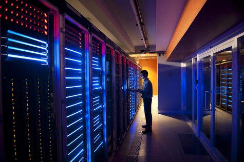 Cybersecurity specialist managing servers in a secure data centre environment.