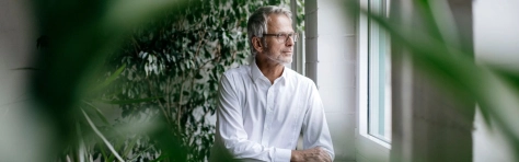 Man looking out of a window thinking about effective IHT planning structures