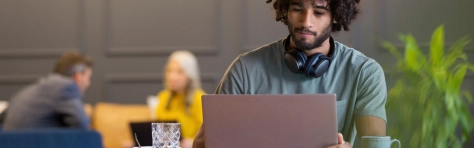 Image of a businessman using laptop in co-working space