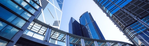 An image of a footbridge and modern office buildings
