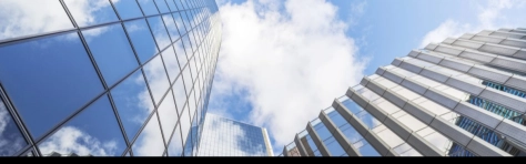 Looking up at modern glass and steel built office buildings