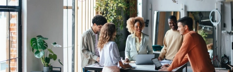 An image of a group of colleagues smiling in the office.