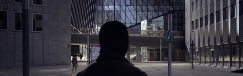 Modern office buildings with silhouette of businessman in front at la defense business district, Paris, France.