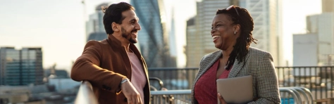 Two people speaking on a balcany