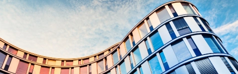 Glass facade of a modern office building in Hamburg, Germany.