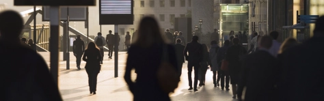 Businesswomen, businessmen and office workers in silhouette, arriving at La Defense business district of Paris, France.