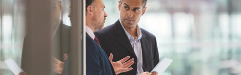 Two colleagues in an office environment talking