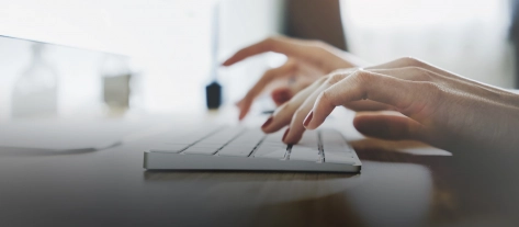 Woman typing computer header 1600x700.jpg