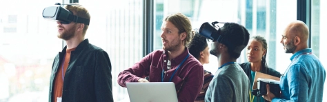 An image of co-workers using technology in the office 