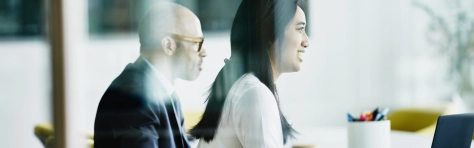 Image of a businessman and businesswomen in a board room 