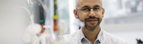 Image of a male scientist sitting in a lab