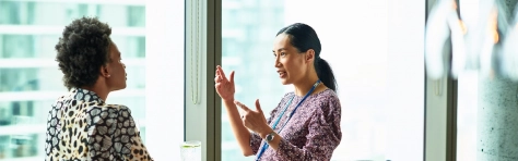Business women discussing, conversation, manager, employee, indoor office, modern building, light, window, watch