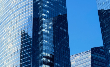 Modern glass office buildings reflecting the blue sky in a financial district in a European city