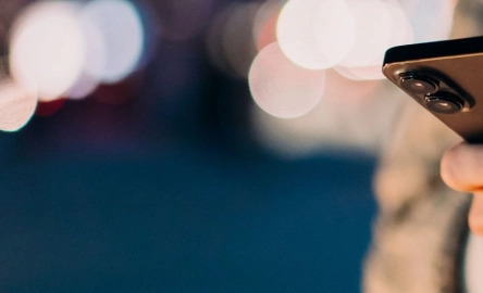 Hands operating an iPhone