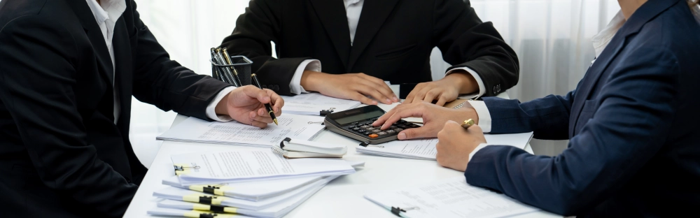 5bfed9aef66c-corporate-accountant-team-use-calculator-calculate-financial-report-shrewd.jpg.webp