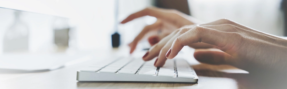 27100f247f0b-Woman-typing-computer-header-1600x500.jpg.webp