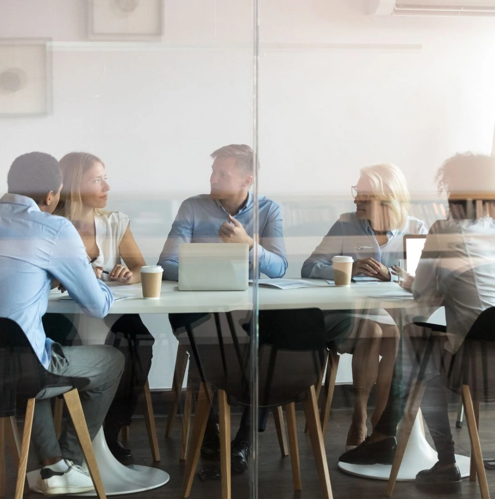 Consulting services team collaborating with clients during a business strategy meeting