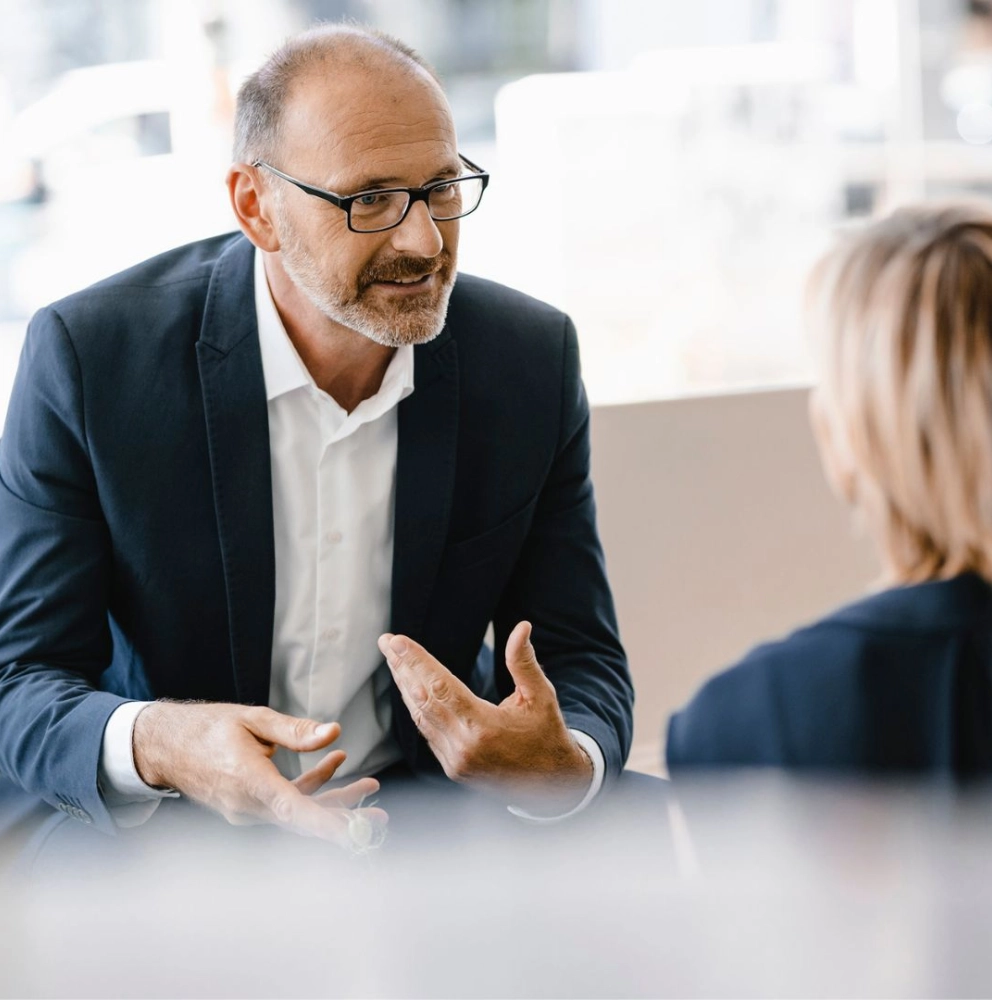 Forvis Mazars employee discussing VAT and indirect tax services with a client