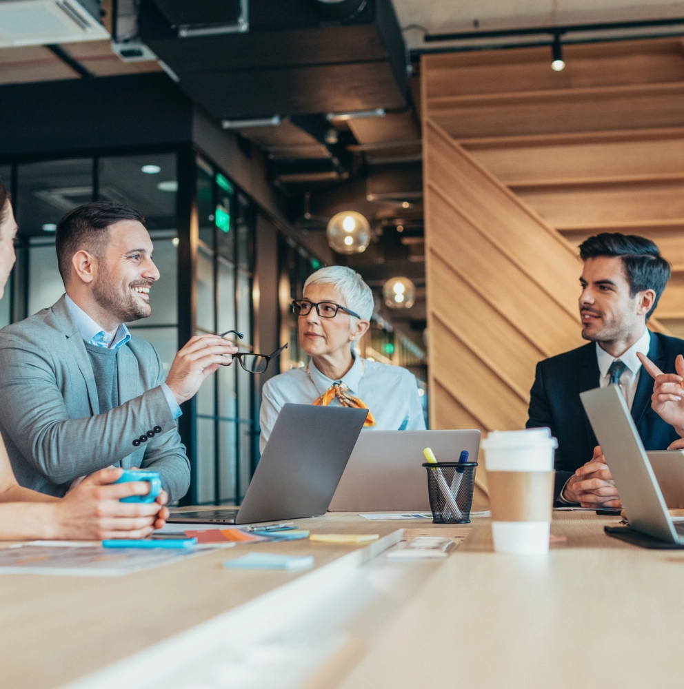 Business professionals discussing tax and regulatory topics during a meeting, illustrating insights from the Swiss Tax Newsletter March 2026.