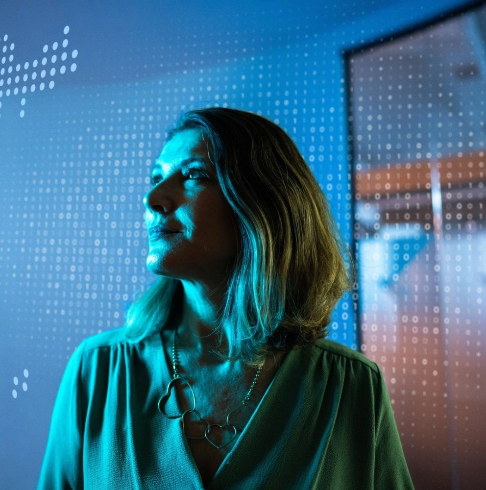 Woman looking into distance thinking about  how digital technologies, intelligent automation and artificial intelligence are changing how work can be performed.
