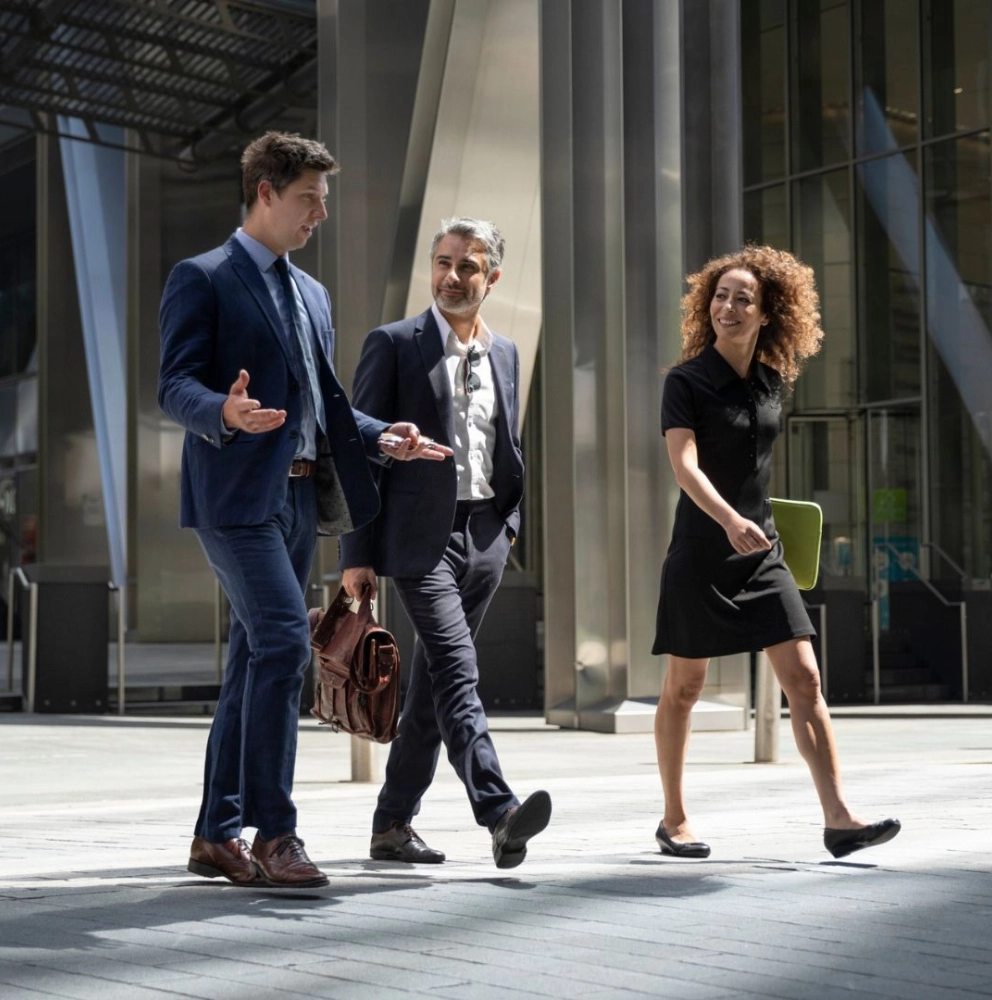 Consulting services advisers discussing business strategy and organisational performance outside a modern office building
