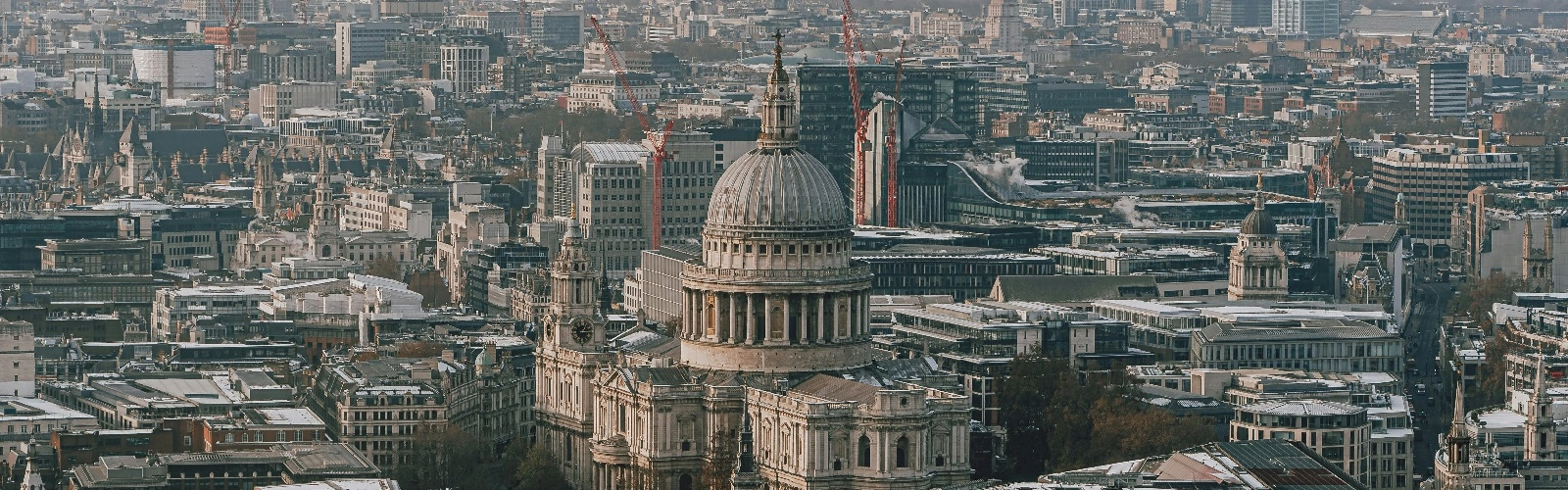View of central London skyline in sunny daytime scene. St Pauls Cathedral with tall British city skyscrapers in England, UK.