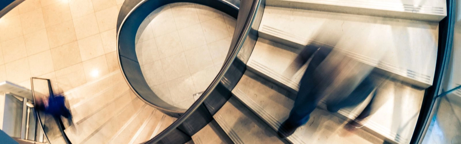 Staircase spiralling down representing US tarrifs causing the market dip and how UK businesses can work around changes.