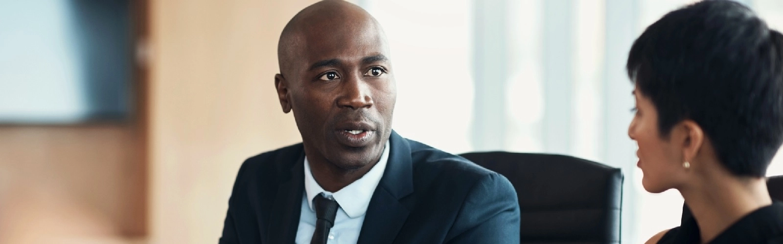 Black man, leadership and corporate meeting in office with executive management, investor feedback and strategy. Professional business manager, team discussion and CEO in financial investment seminar