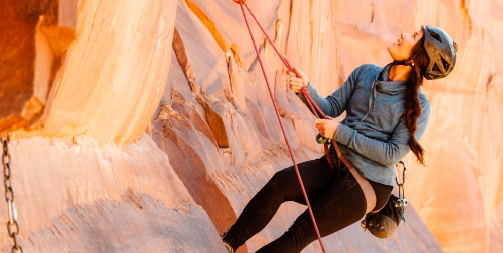 An image of a women rock climbing